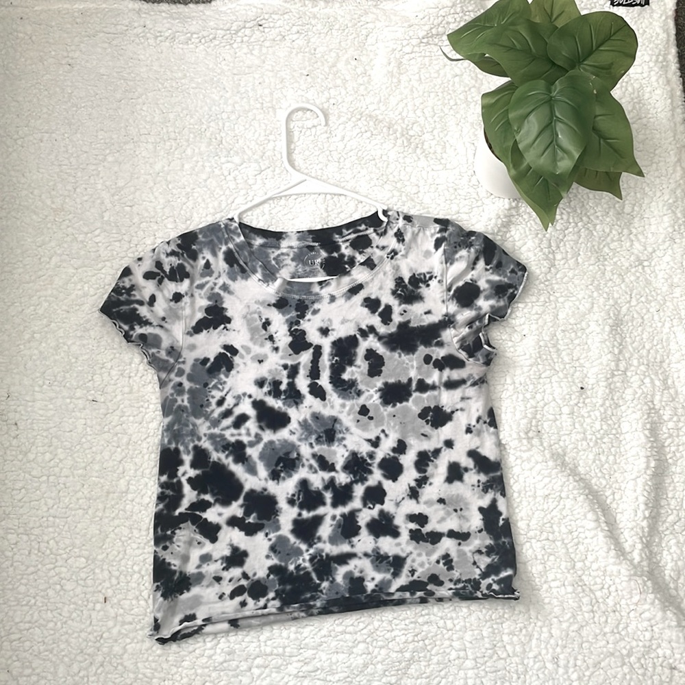 The brand is called urban rebel. It’s a white , grey , and black shirt.